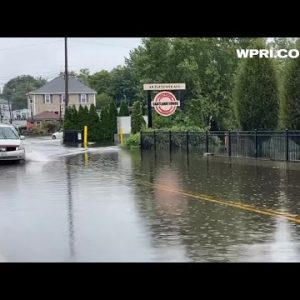 VIDEO NOW: Drivers going through flooded street in Cranston